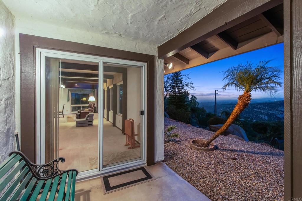 28969 Mountain Meadow Road Escondido, CA 92026 - Photo 7 of 25 a view of a porch with a floor to ceiling window and wooden floor