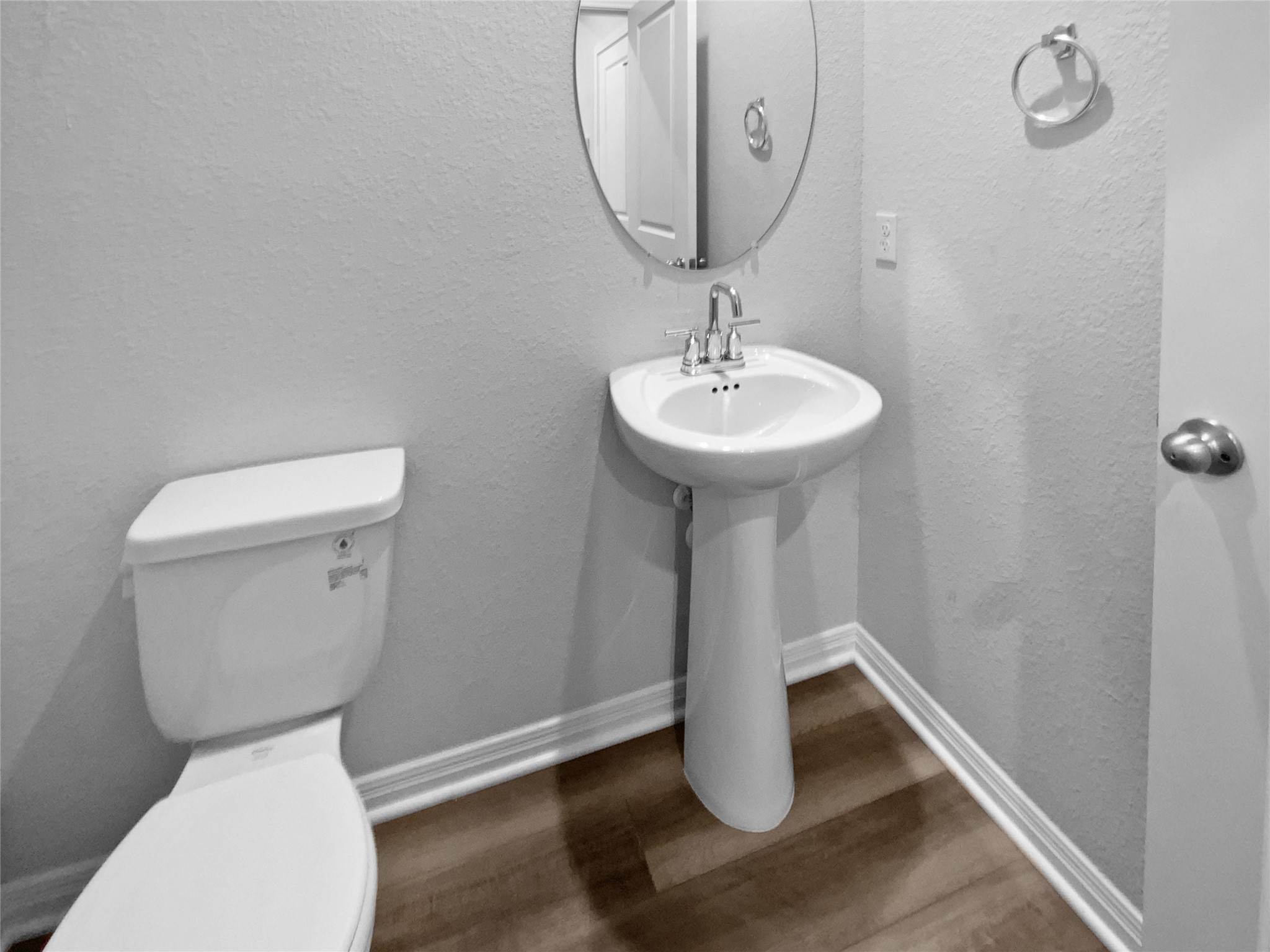 220 Sungrove Trail Georgetown, TX 78628 - Photo 15 of 23 Half bath with a textured wall and dark wood-style flooring