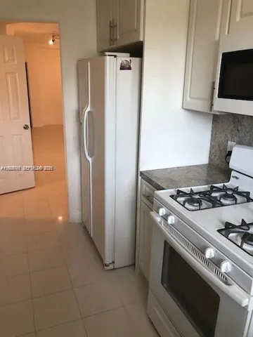 a stove top oven sitting inside of a kitchen