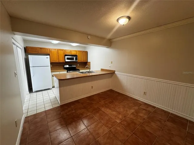a kitchen with granite countertop a sink and a stove top oven
