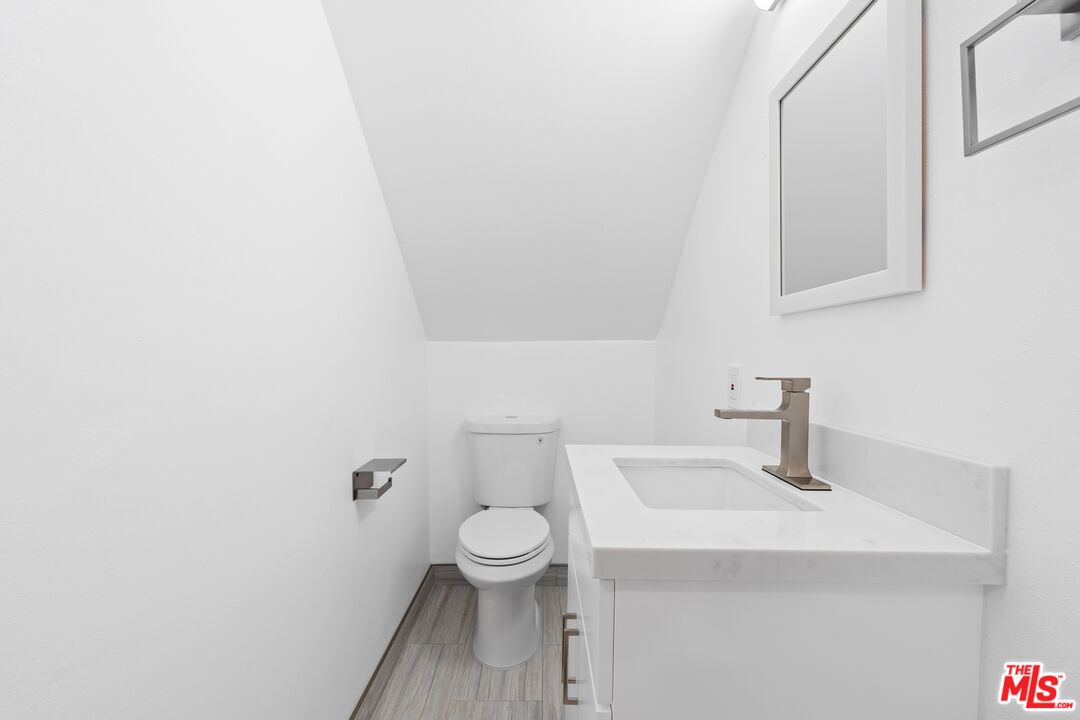 122 Buccaneer Street, Unit 1 Marina del Rey, CA 90292 - Photo 13 of 21 a bathroom with a sink a toilet and mirror