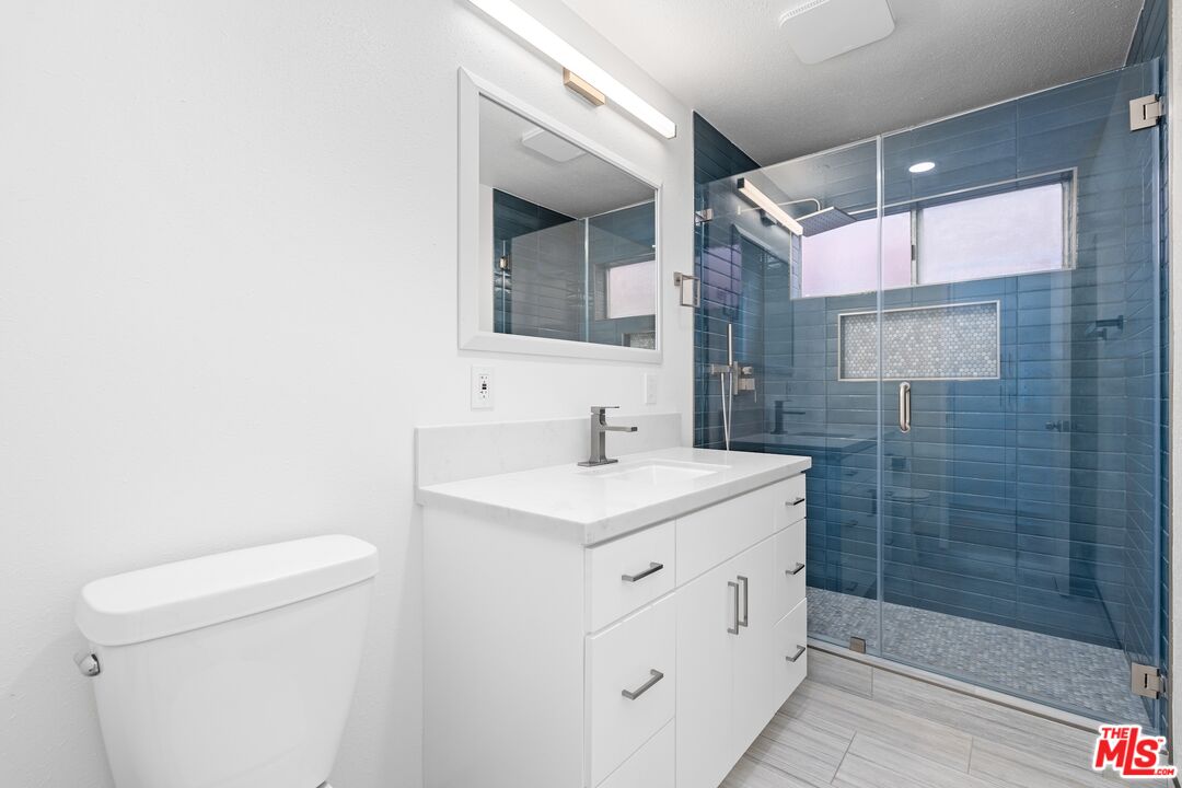 122 Buccaneer Street, Unit 1 Marina del Rey, CA 90292 - Photo 14 of 21 a bathroom with a sink a toilet a mirror and shower