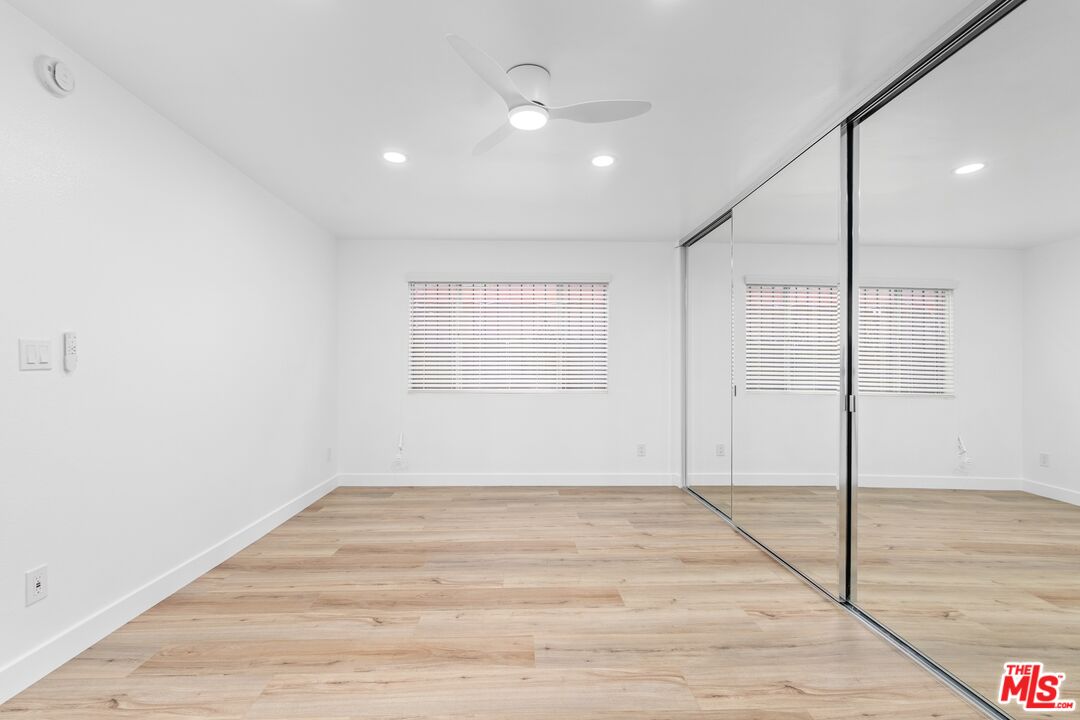 122 Buccaneer Street, Unit 1 Marina del Rey, CA 90292 - Photo 16 of 21 a view of an empty room with wooden floor and a window