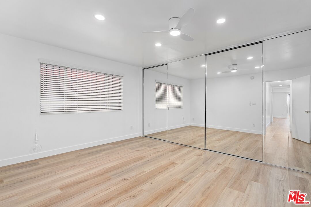 122 Buccaneer Street, Unit 1 Marina del Rey, CA 90292 - Photo 17 of 21 a view of an empty room with wooden floor and a window