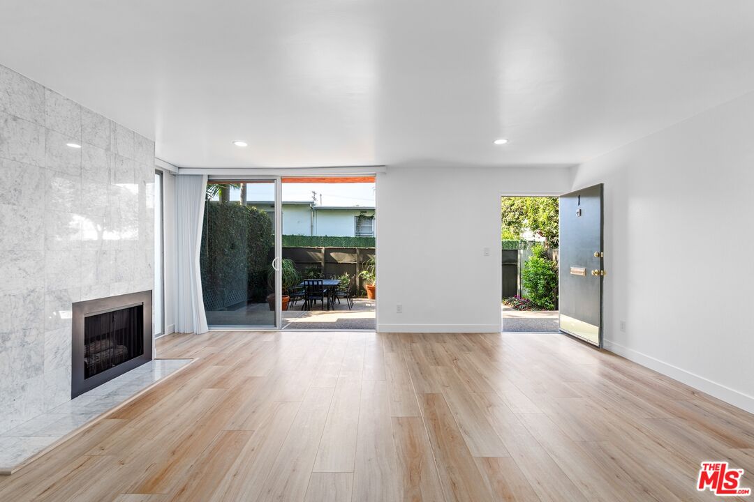 122 Buccaneer Street, Unit 1 Marina del Rey, CA 90292 - Photo 3 of 21 a view of an empty room with glass door and a window