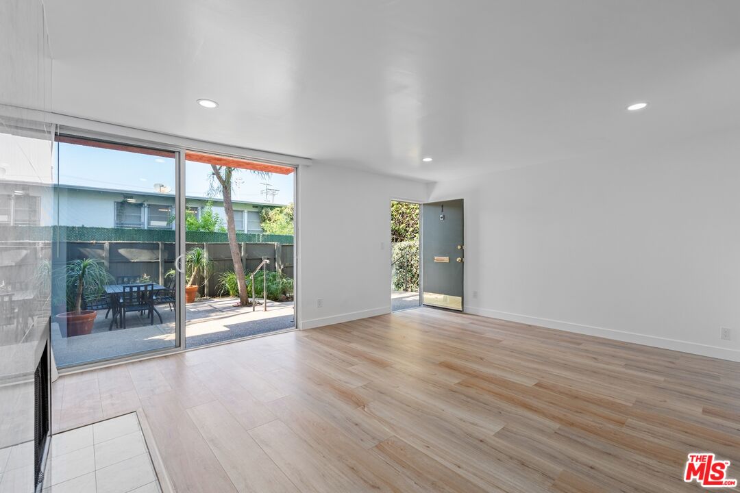 122 Buccaneer Street, Unit 1 Marina del Rey, CA 90292 - Photo 4 of 21 a view of an empty room with wooden floor and a window