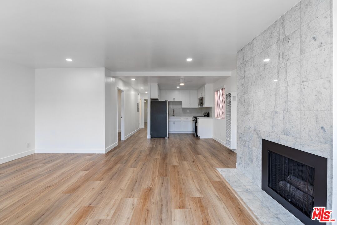 122 Buccaneer Street, Unit 1 Marina del Rey, CA 90292 - Photo 6 of 21 a view of kitchen and empty room with wooden floor