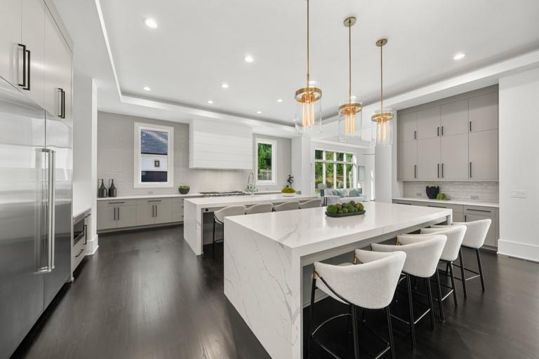 5211 Powers Ferry Road Northwest Sandy Springs, GA 30327 - Photo 21 of 106 a kitchen with stainless steel appliances granite countertop a sink a stove a refrigerator and a dining table with wooden floor
