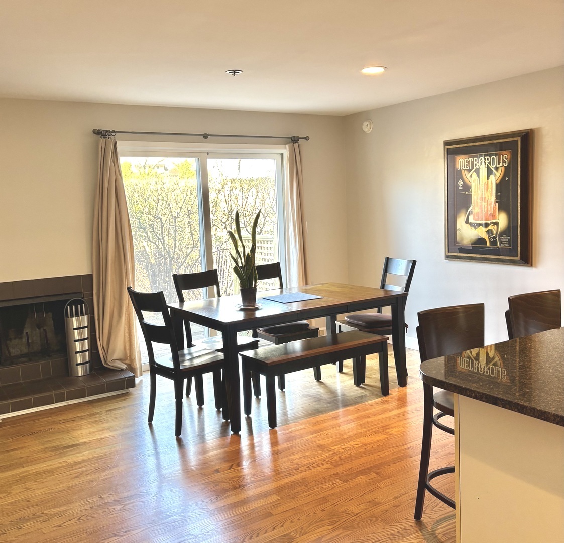 1229 Central Street, Unit A Evanston, IL 60201 - Photo 6 of 14 a view of a dining room with furniture and wooden floor