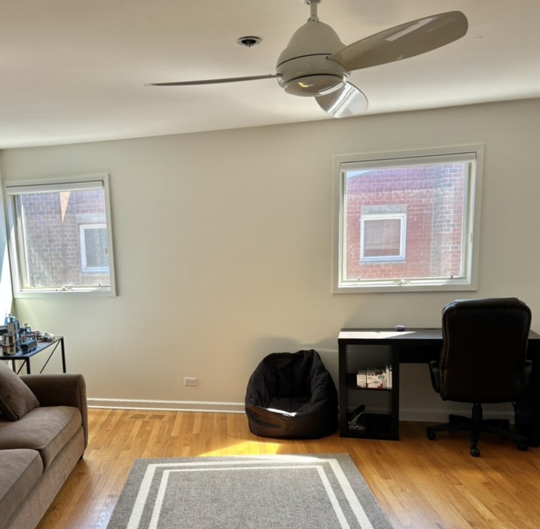 1229 Central Street, Unit A Evanston, IL 60201 - Photo 9 of 14 a room with a couch and a chair