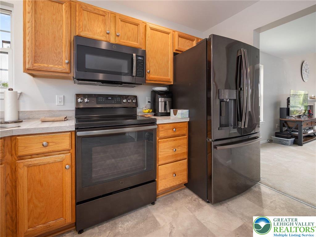 2309 Juniper Drive Coplay, PA 18037 - Photo 32 of 49 a kitchen with granite countertop a refrigerator stove and microwave