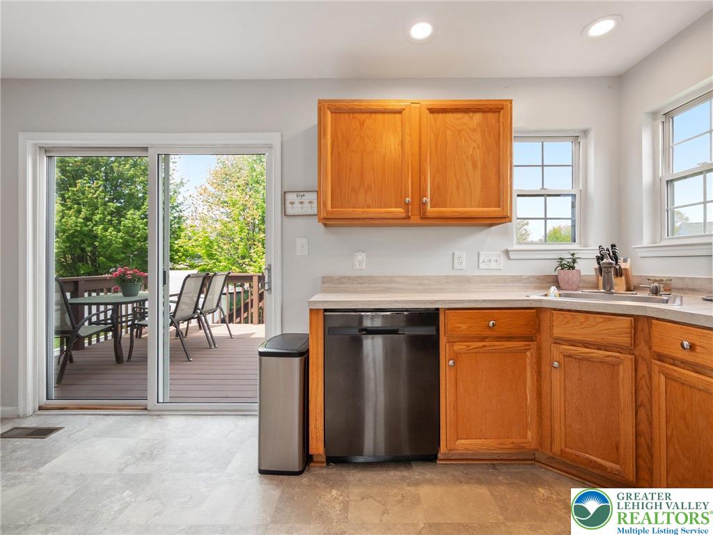 2309 Juniper Drive Coplay, PA 18037 - Photo 33 of 49 a kitchen with stainless steel appliances granite countertop wooden cabinets a sink and a stove
