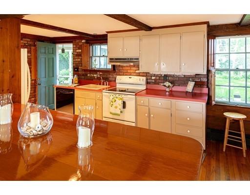 10 Batchelder Road Marblehead, MA 01945 - Photo 6 of 23 a kitchen with a stove a refrigerator and a dining table