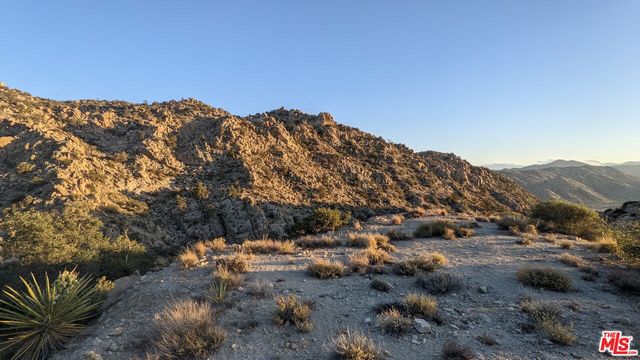 a view of a large building with mountains in the background