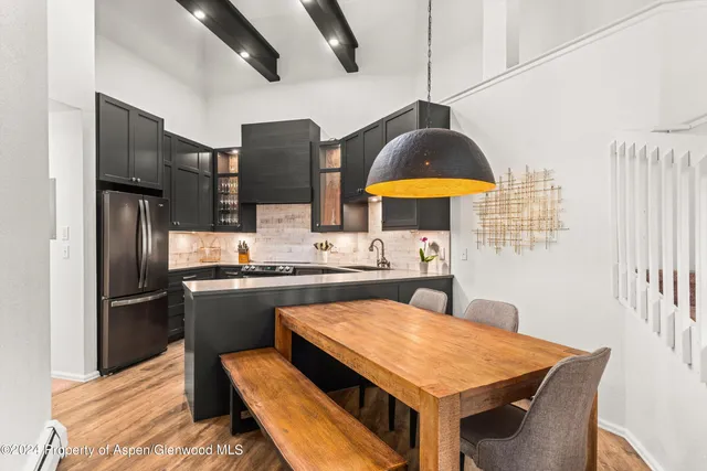 a kitchen with stainless steel appliances granite countertop a sink a stove and refrigerator