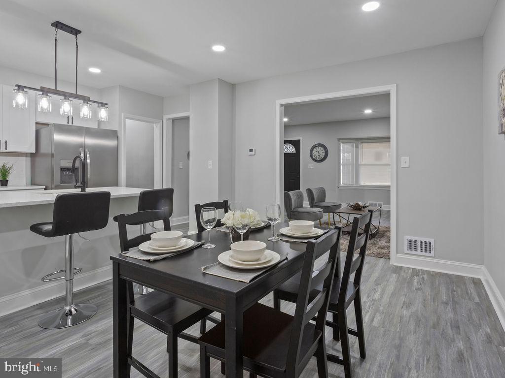 5716 Leith Walk Baltimore, MD 21239 - Photo 11 of 36 a view of a dining room with furniture and wooden floor