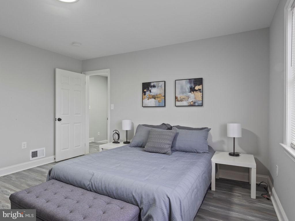 5716 Leith Walk Baltimore, MD 21239 - Photo 13 of 36 a bedroom with a bed and a lamp