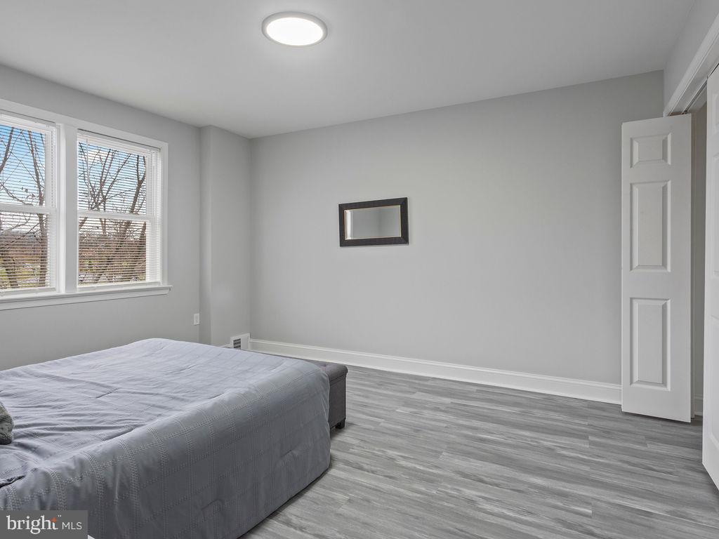 5716 Leith Walk Baltimore, MD 21239 - Photo 15 of 36 a bedroom with a bed and a window