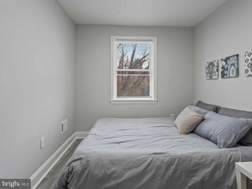 5716 Leith Walk Baltimore, MD 21239 - Photo 19 of 36 a bedroom with a bed and a window