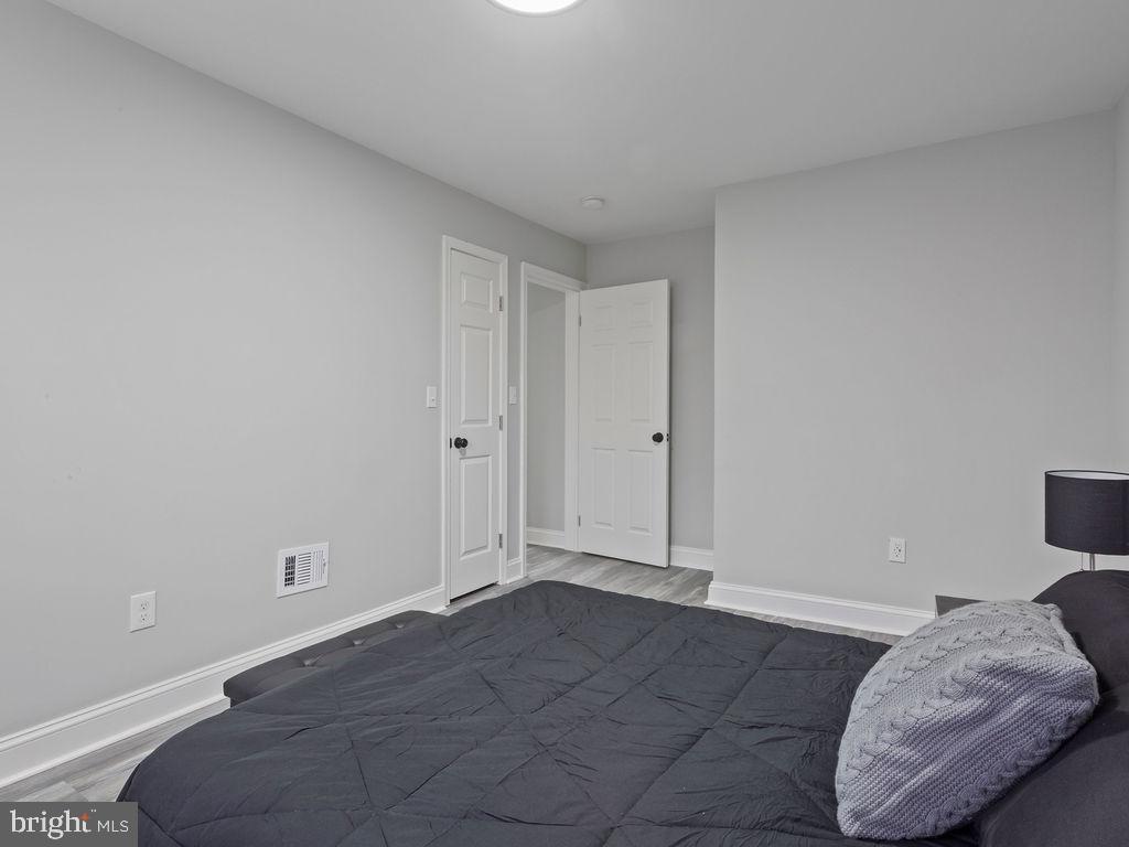 5716 Leith Walk Baltimore, MD 21239 - Photo 23 of 36 a view of livingroom and bedroom with a baby bed