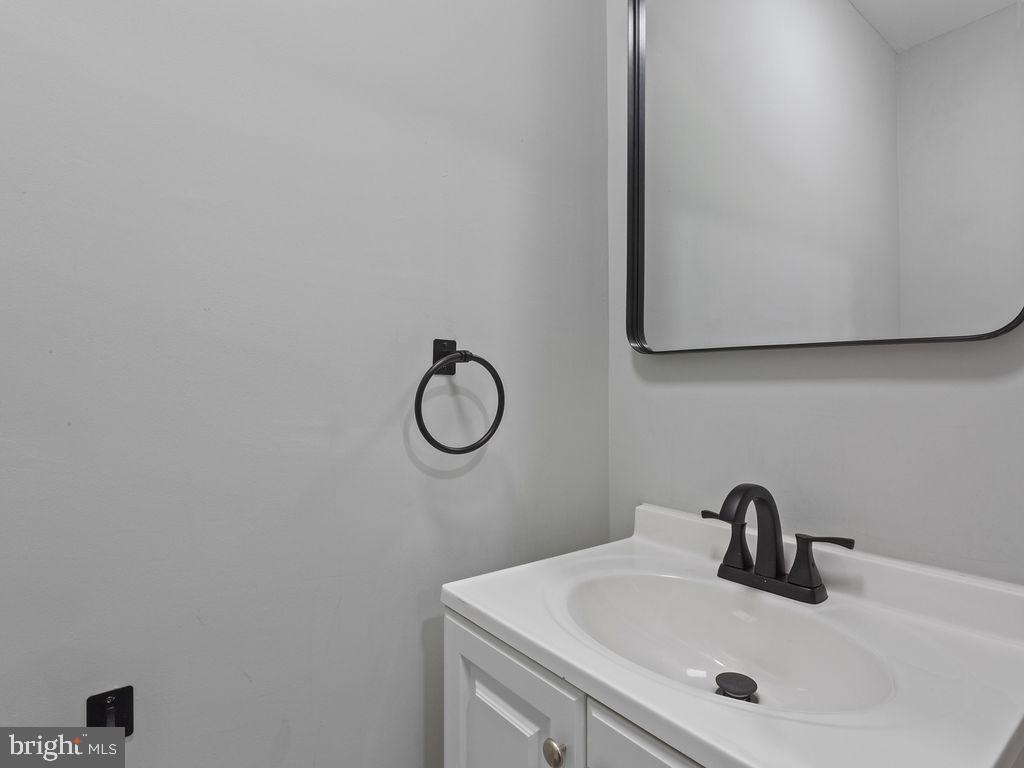 5716 Leith Walk Baltimore, MD 21239 - Photo 25 of 36 a bathroom with a sink and a mirror