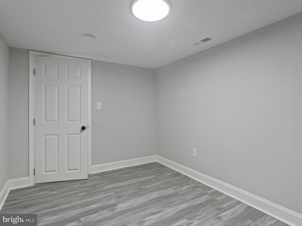 5716 Leith Walk Baltimore, MD 21239 - Photo 28 of 36 a view of an empty room and wooden floor