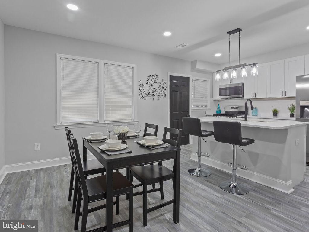 5716 Leith Walk Baltimore, MD 21239 - Photo 10 of 36 a view of a a dining room with furniture window and wooden floor