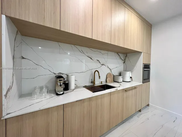 a kitchen with sink and cabinets