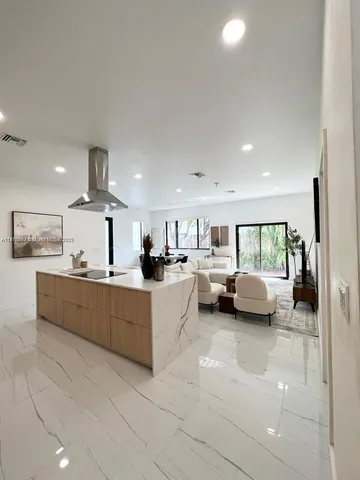 a large white kitchen with a large window