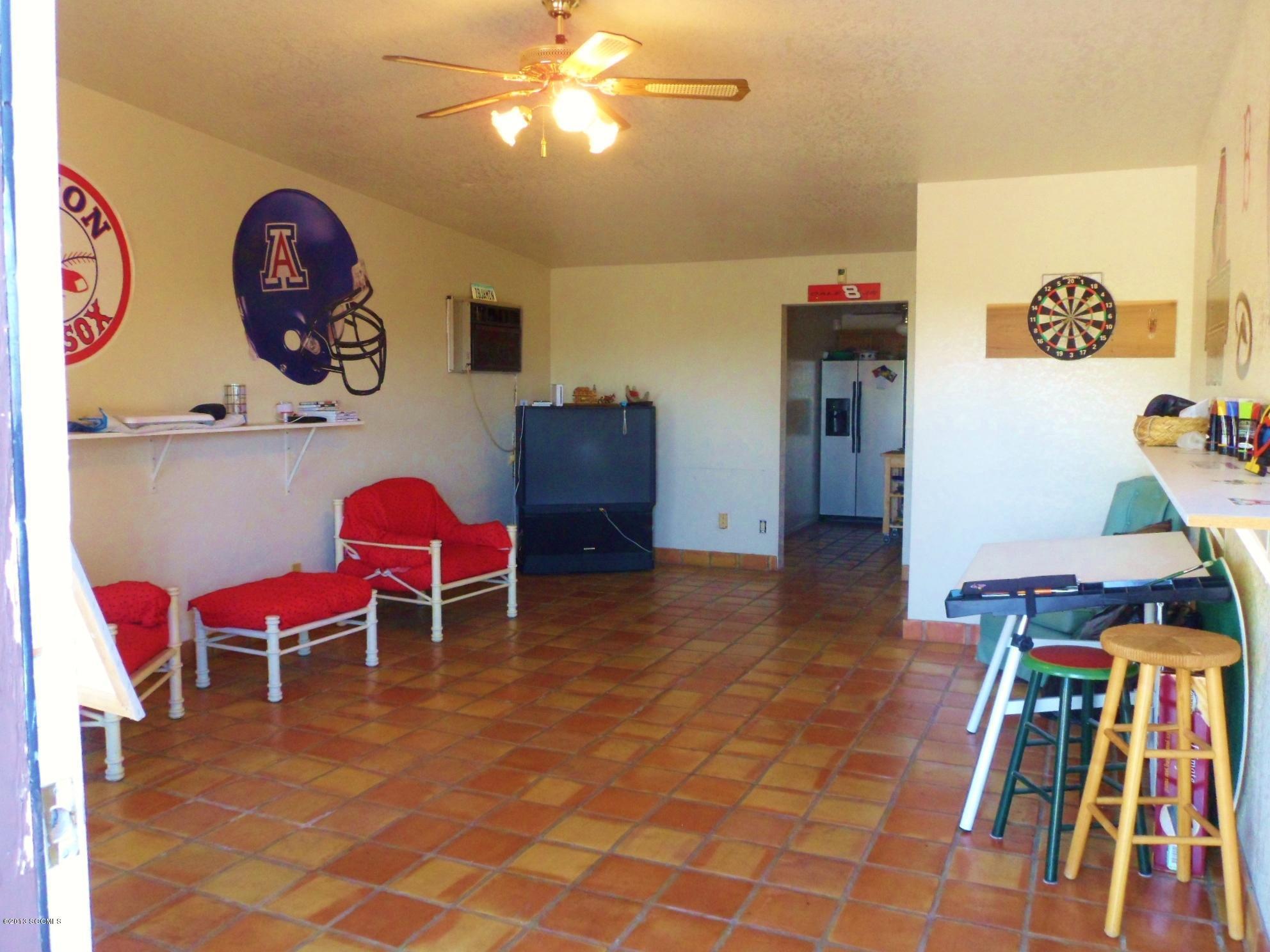 293 Cuenta Court Rio Rico, AZ 85648 - Photo 18 of 25 a view of a workspace with furniture and wooden floor