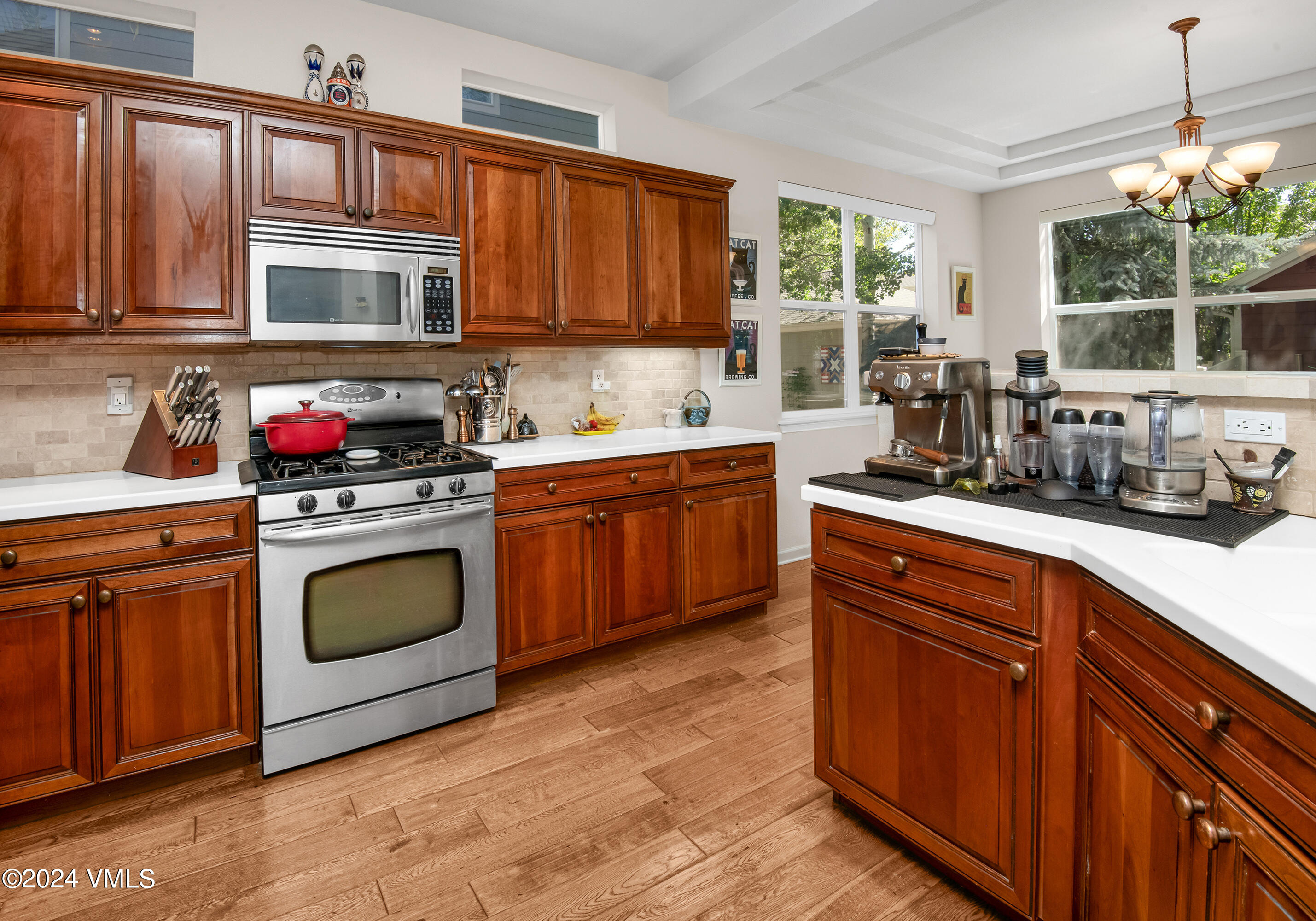 216 Mayer Street Eagle, CO 81631 - Photo 4 of 51 a kitchen with stainless steel appliances granite countertop a stove a sink dishwasher and cabinets with wooden floor