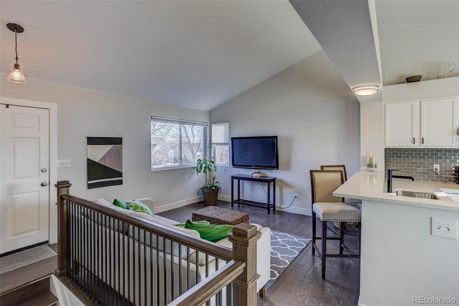 2939 Benton Street Wheat Ridge, CO 80214 - Photo 5 of 29 a living room with furniture a flat screen tv and a window