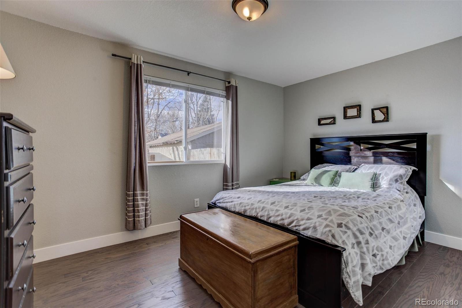 2939 Benton Street Wheat Ridge, CO 80214 - Photo 8 of 29 a bedroom with a bed and a window