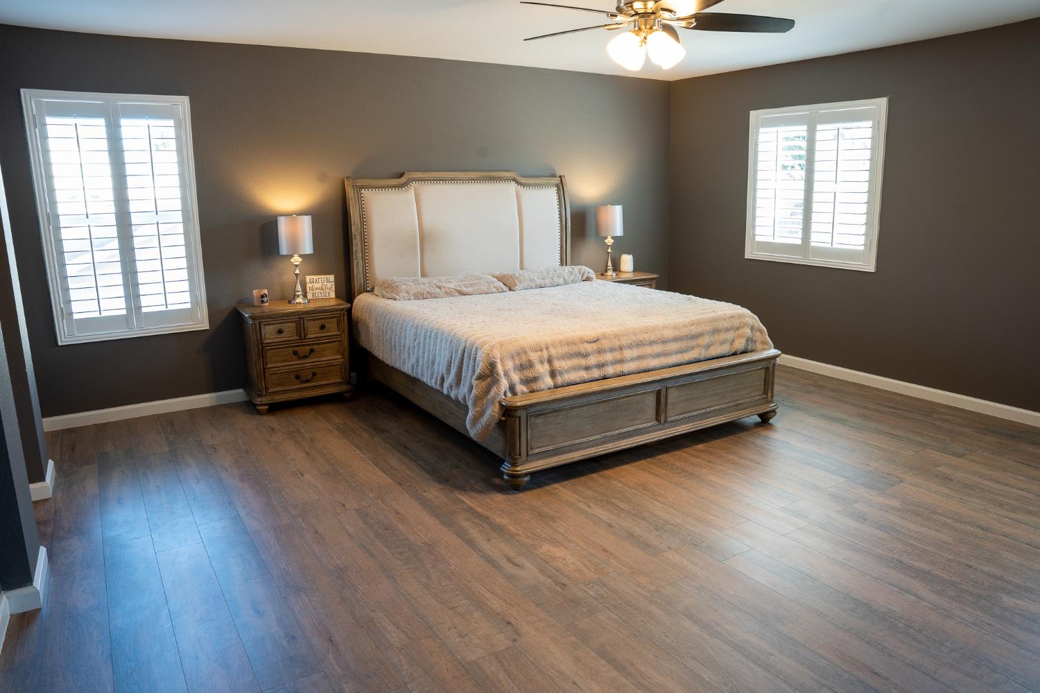 10961 Woolwich Way Mather, CA 95655 - Photo 20 of 28 a spacious bedroom with a bed and a chandelier