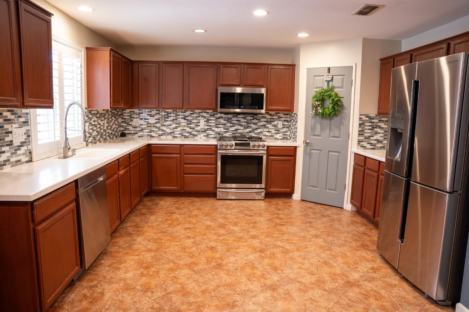 10961 Woolwich Way Mather, CA 95655 - Photo 4 of 28 a kitchen with stainless steel appliances a refrigerator sink and microwave
