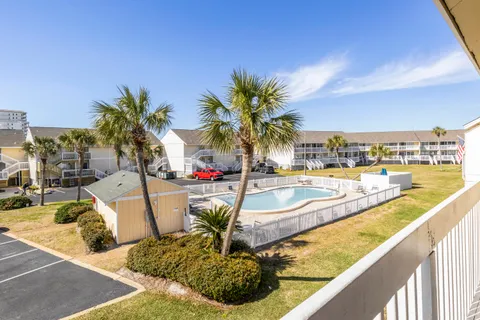 a view of swimming pool with outdoor seating and plants