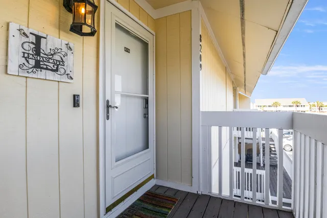 a view of a hallway with wooden floor and entryway