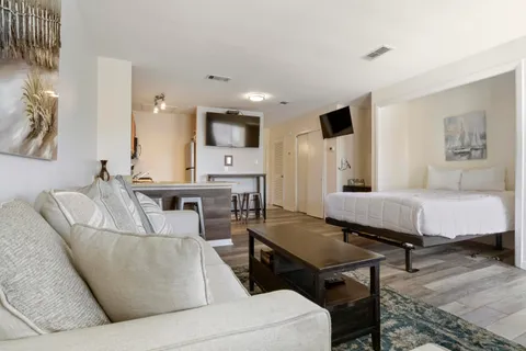 a living room with furniture and a wooden floor