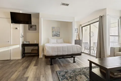 a bedroom with a bed and a flat screen tv