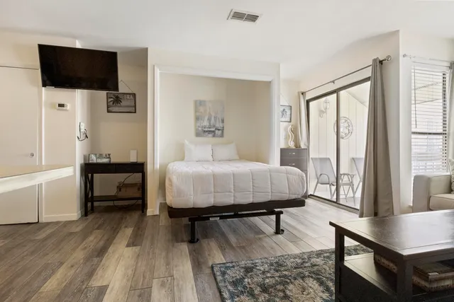 a bedroom with a bed and a flat screen tv