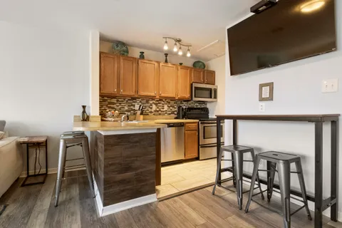 a kitchen with a table chairs refrigerator and cabinets