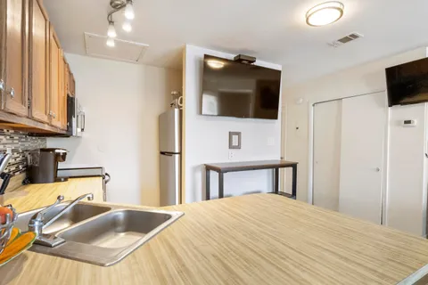 a bedroom with a bed and flat screen tv