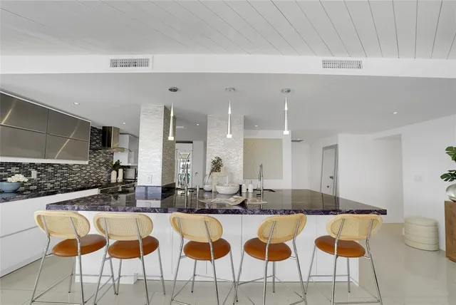 a view of a kitchen with a sink dishwasher a washer and dryer