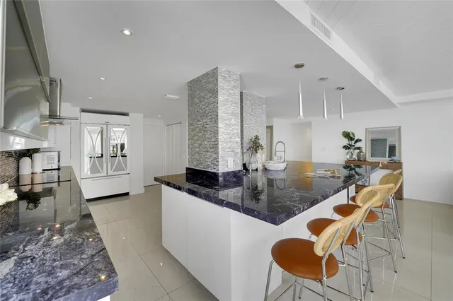 a kitchen with stainless steel appliances a sink stove and cabinets