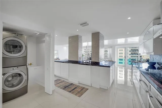 a kitchen with stainless steel appliances granite countertop a stove a sink and a refrigerator