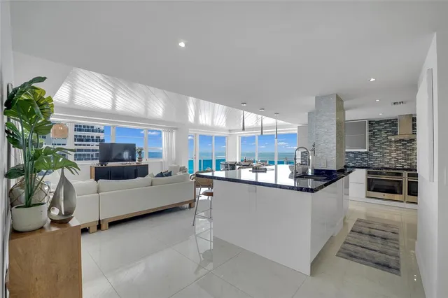 a view of a dining room with furniture and a chandelier