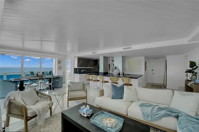 a living room with furniture a rug and a large window