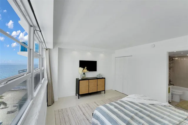 a spacious bedroom with a bed and table