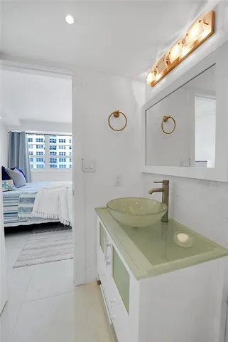 a bathroom with a granite countertop sink a toilet and shower