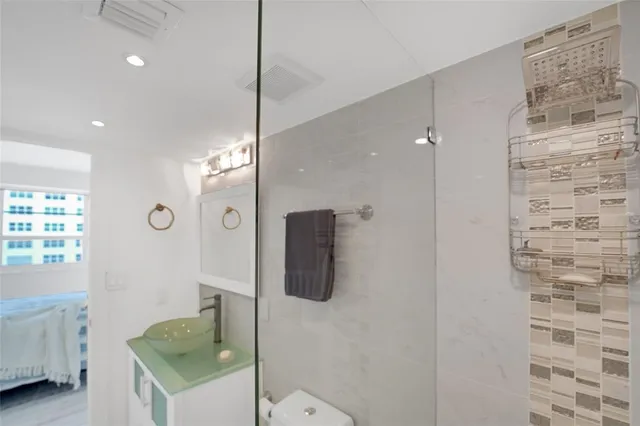 a bathroom with a sink toilet and shower